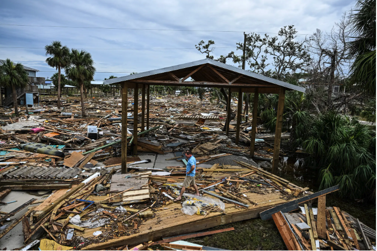 People try and pick up the pieces on September 28, 2024 after Hurricane Helene sweeps through Horseshoe Beach in Florida. Courtesy of ProPublica, Getty, AFP, and photo by Chandan Khanna